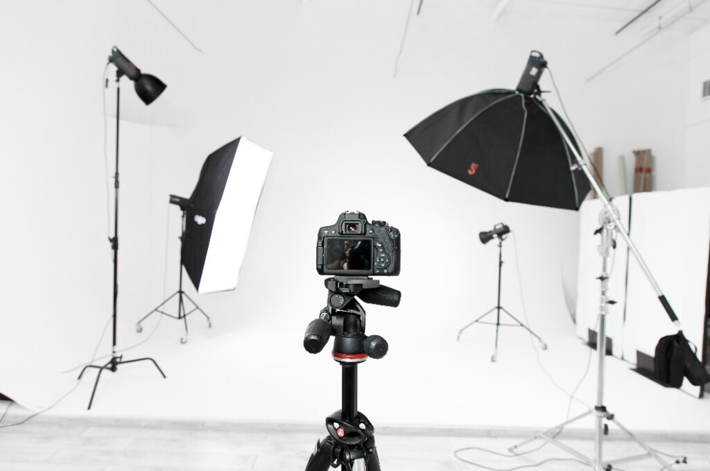 Empty photo studio with lighting equipment and camera